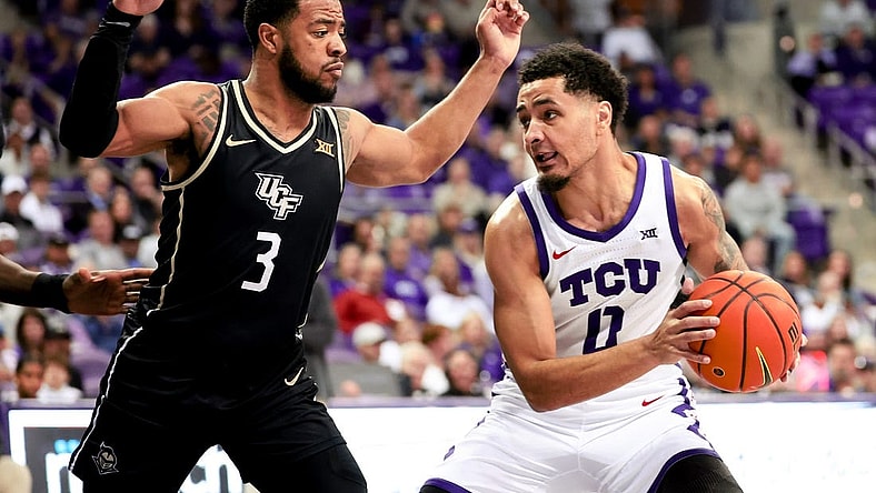 Mar 9, 2024; Fort Worth, Texas, USA;  TCU Horned Frogs guard Micah Peavy (0) controls the ball as UCF Knights guard Darius Johnson (3) defends during the first half at Ed and Rae Schollmaier Arena. Mandatory Credit: Kevin Jairaj-USA TODAY Sports