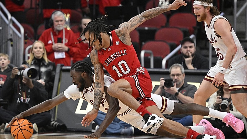 Mar 9, 2024; Louisville, Kentucky, USA;  Boston College Eagles guard Prince Aligbe (10) dives for the ball with Louisville Cardinals forward Kaleb Glenn (10) during the first half at KFC Yum! Center. Mandatory Credit: Jamie Rhodes-USA TODAY Sports