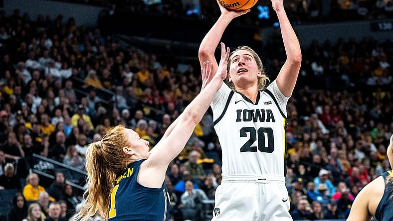 Iowa guard Kate Martin (20) attempts a shot against Michigan guard Lauren Hansen (1) during the Big Ten Tournament semifinals at the Target Center on Saturday, March 9, 2024, in Minneapolis, Minn.