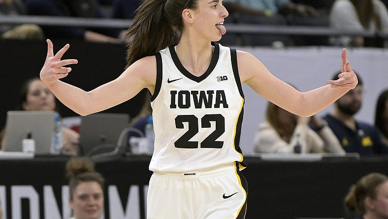 Mar 9, 2024; Minneapolis, MN, USA;  Iowa Hawkeyes guard Caitlin Clark (22) celebrates a three-pointer just inside the half-court line Michigan Wolverines during the first half of the Big Ten Women's Basketball tournament semifinal at Target Center. Mandatory Credit: Nick Wosika-USA TODAY Sports