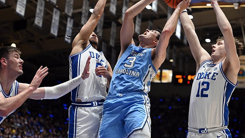 Mar 9, 2024; Durham, North Carolina, USA; North Carolina Tar Heels guard Cormac Ryan (3) shoots over  Duke Blue Devils guard Jared McCain (0) during the first half at Cameron Indoor Stadium. Mandatory Credit: Rob Kinnan-USA TODAY Sports