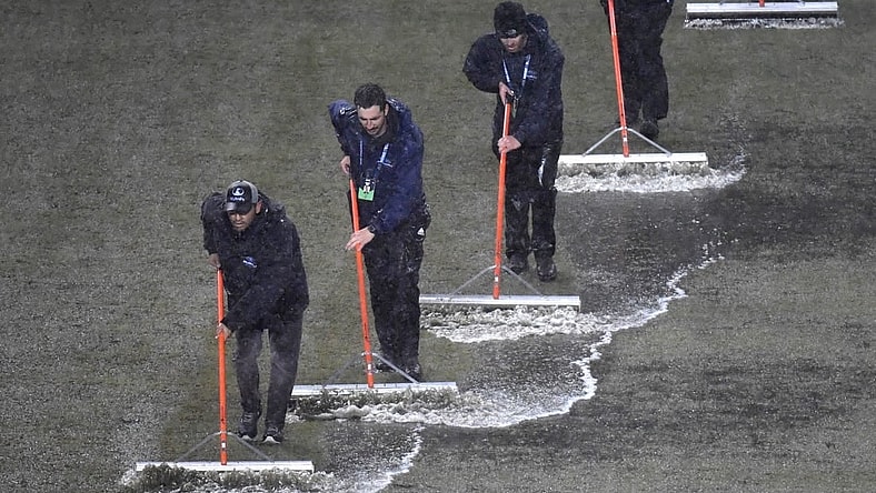 Mar 9, 2024; Philadelphia, Pennsylvania, USA; Members of the stadium grounds crew squeegee the field during a rain delay in the match between the Seattle Sounders FC and the Philadelphia Union at Subaru Park. Mandatory Credit: Eric Hartline-USA TODAY Sports