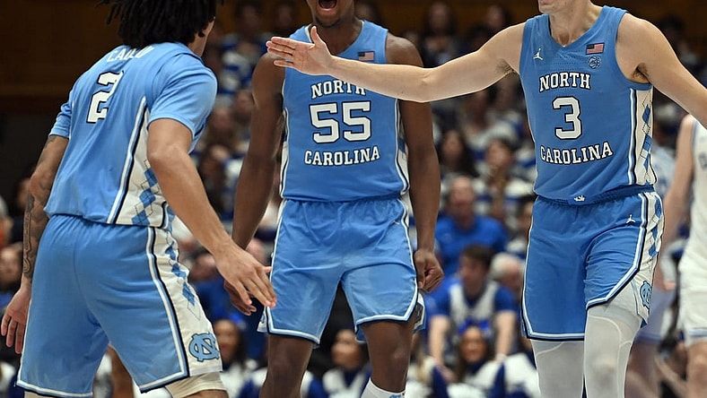 Mar 9, 2024; Durham, North Carolina, USA; North Carolina Tar Heels guard Cormac Ryan (3) and forward Harrison Ingram (55) react to a basket by guard Elliot Cadeau (2) during the second half against the Duke Blue Devils at Cameron Indoor Stadium. The Tar Heels won 84-79. Mandatory Credit: Rob Kinnan-USA TODAY Sports