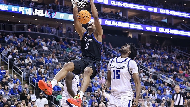 Mar 9, 2024; Newark, New Jersey, USA;  DePaul Blue Demons center Churchill Abass (5) dunks past Seton Hall Pirates center Jaden Bediako (15) in the first half at Prudential Center. Mandatory Credit: Wendell Cruz-USA TODAY Sports