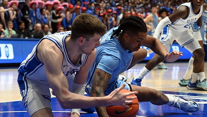 Mar 9, 2024; Durham, North Carolina, USA; North Carolina Tar Heels forward Armando Bacot (5) grabs a loose ball from Duke Blue Devils center Kyle Filipowski (30) during the first half at Cameron Indoor Stadium. Mandatory Credit: Rob Kinnan-USA TODAY Sports