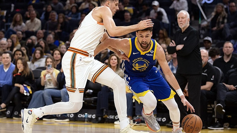 Mar 9, 2024; San Francisco, California, USA; Golden State Warriors guard Klay Thompson (11) drives around San Antonio Spurs forward Zach Collins (23) during the second quarter at Chase Center. Mandatory Credit: D. Ross Cameron-USA TODAY Sports