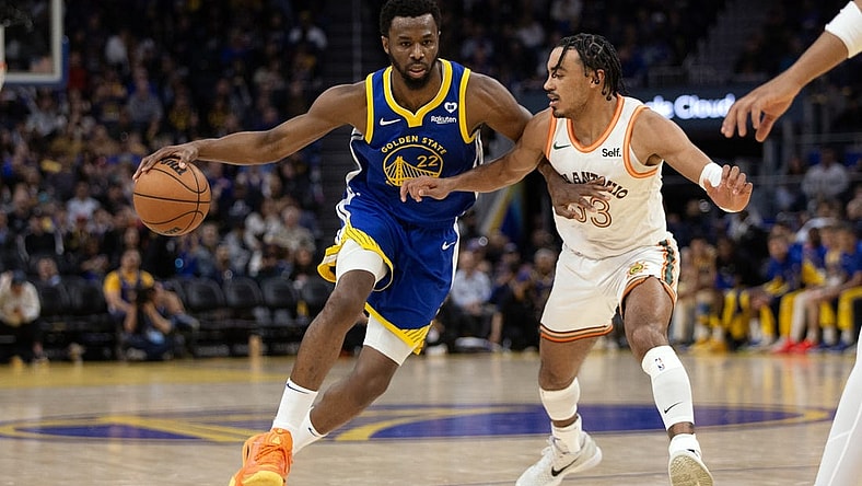 Mar 9, 2024; San Francisco, California, USA; Golden State Warriors forward Andrew Wiggins (22) tries to drive around San Antonio Spurs guard Tre Jones (33) during the second quarter at Chase Center. Mandatory Credit: D. Ross Cameron-USA TODAY Sports