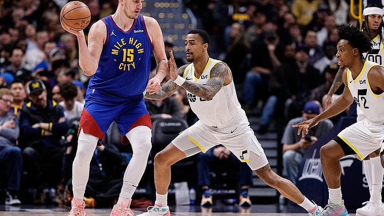 Mar 9, 2024; Denver, Colorado, USA; Denver Nuggets center Nikola Jokic (15) looks to pass the ball as Utah Jazz forward John Collins (20) guards in the second quarter at Ball Arena. Mandatory Credit: Isaiah J. Downing-USA TODAY Sports
