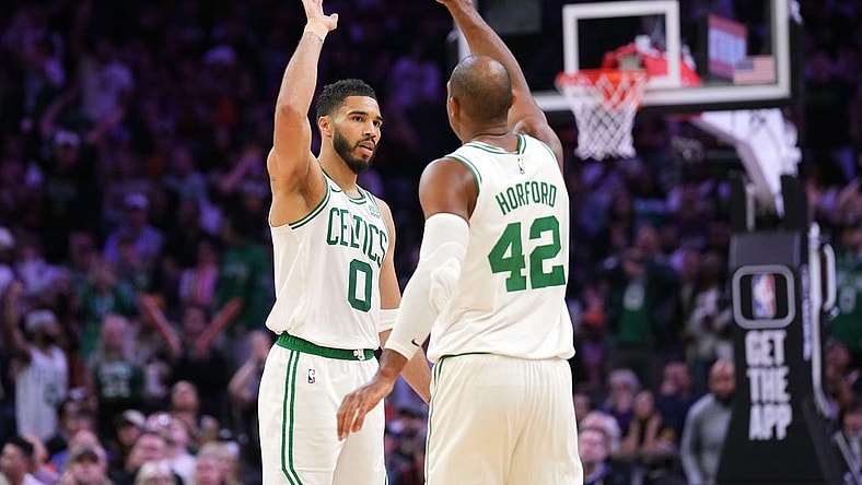 Mar 9, 2024; Phoenix, Arizona, USA; Boston Celtics forward Jayson Tatum (0) and Boston Celtics center Al Horford (42) slap hands during the second half of the game against the Phoenix Suns at Footprint Center. Mandatory Credit: Joe Camporeale-USA TODAY Sports