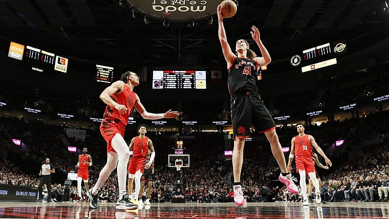 Mar 9, 2024; Portland, Oregon, USA; Toronto Raptors power forward Kelly Olynyk (41) shoots the ball as Portland Trail Blazers guard Dalano Banton (5) looks on during the first half at Moda Center. Mandatory Credit: Soobum Im-USA TODAY Sports