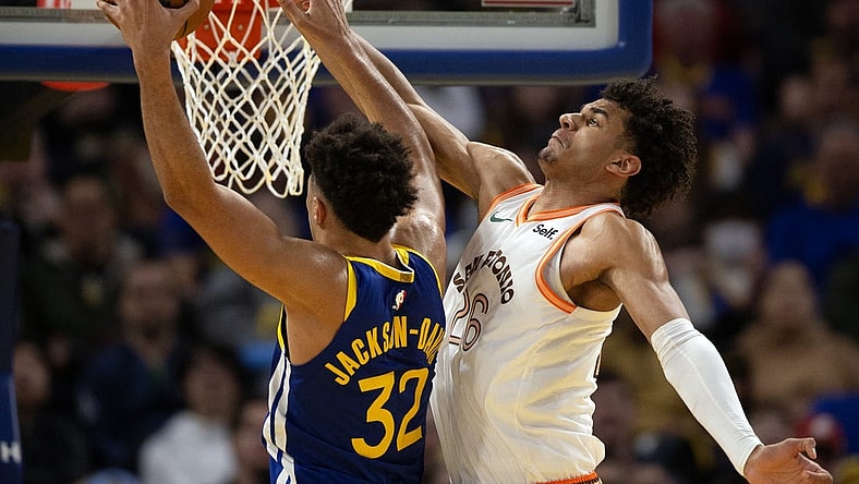 Mar 9, 2024; San Francisco, California, USA; Golden State Warriors forward Trayce Jackson-Davis (32) manages to get a shot around the defense of San Antonio Spurs forward Dominick Barlow (26) during the third quarter at Chase Center. Mandatory Credit: D. Ross Cameron-USA TODAY Sports