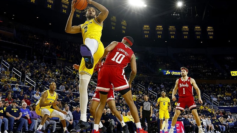 Mar 10, 2024; Ann Arbor, Michigan, USA;  Michigan Wolverines forward Tray Jackson (2) grabs the rebound over Nebraska Cornhuskers guard Jamarques Lawrence (10) in the first half at Crisler Center. Mandatory Credit: Rick Osentoski-USA TODAY Sports