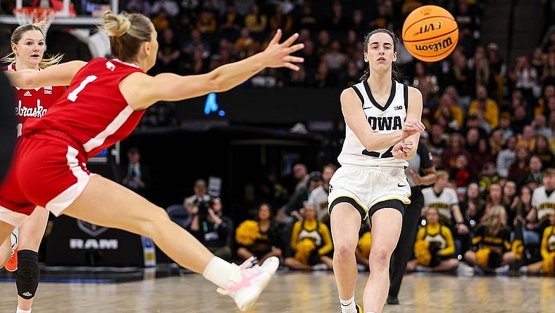 Mar 10, 2024; Minneapolis, MN, USA; Iowa Hawkeyes guard Caitlin Clark (22) passes as Nebraska Cornhuskers guard Jaz Shelley (1) defends during the first half at Target Center. Mandatory Credit: Matt Krohn-USA TODAY Sports