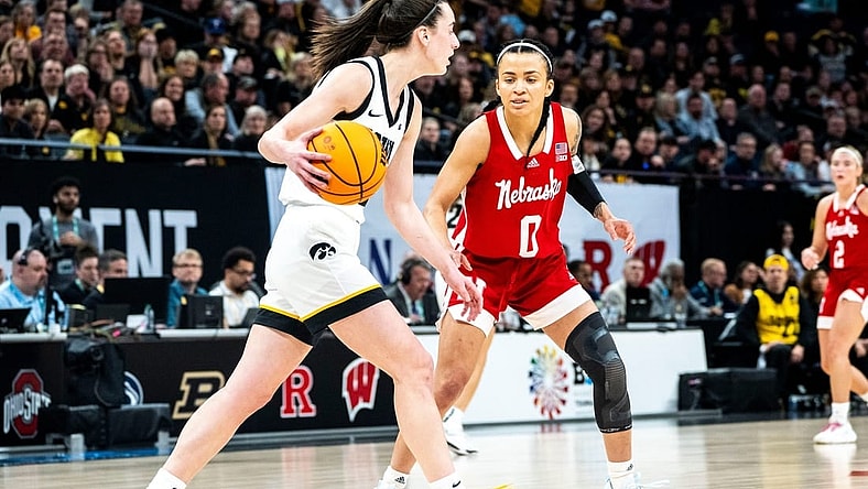 Iowa guard Caitlin Clark (22) dribbles the ball against Nebraska guard Darian White during the Big Ten Tournament championship game at the Target Center on Sunday, March 10, 2024, in Minneapolis, Minn.