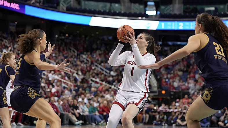 Mar 10, 2024; Greensboro, NC, USA; NC State Wolfpack center River Baldwin (1) shoots the ball over a defender in the first half against the Notre Dame Fighting Irish at Greensboro Coliseum. Mandatory Credit: David Yeazell-USA TODAY Sports