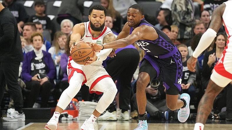 Mar 10, 2024; Sacramento, California, USA; Sacramento Kings guard De'Aaron Fox (right) reaches for a pass to Houston Rockets guard Fred VanVleet (left) during the first quarter at Golden 1 Center. Mandatory Credit: Darren Yamashita-USA TODAY Sports