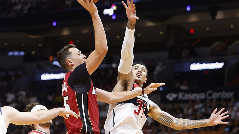 Mar 10, 2024; Miami, Florida, USA; Miami Heat forward Duncan Robinson (55) shoots over Washington Wizards forward Kyle Kuzma (33) in the first half at Kaseya Center. Mandatory Credit: Rhona Wise-USA TODAY Sports