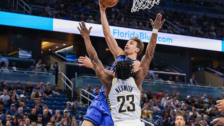 Mar 10, 2024; Orlando, Florida, USA; Orlando Magic forward Franz Wagner (22) goes to the basket against Indiana Pacers forward Aaron Nesmith (23) during the first quarter at KIA Center. Mandatory Credit: Mike Watters-USA TODAY Sports