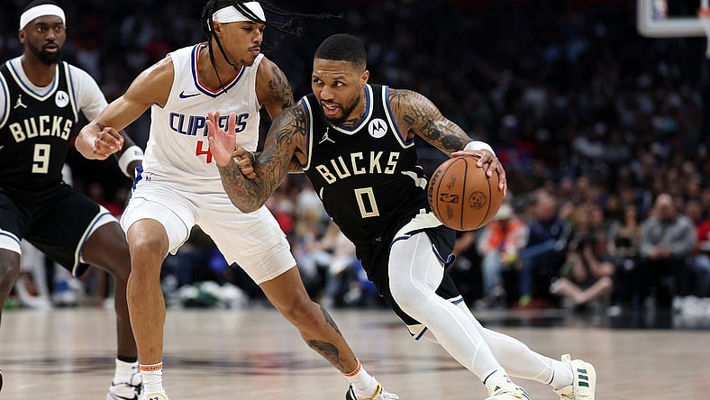 Mar 10, 2024; Los Angeles, California, USA;  Milwaukee Bucks guard Damian Lillard (0) drives to the basket against Los Angeles Clippers guard Brandon Boston Jr. (4) during the third quarter at Crypto.com Arena. Mandatory Credit: Kiyoshi Mio-USA TODAY Sports