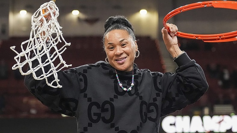 Mar 10, 2024; Greensville, SC, USA;  South Carolina Gamecocks head coach Dawn Staley cuts the net after winning the SEC championship over LSU Lady Tigers at Bon Secours Wellness Arena. Mandatory Credit: Jim Dedmon-USA TODAY Sports