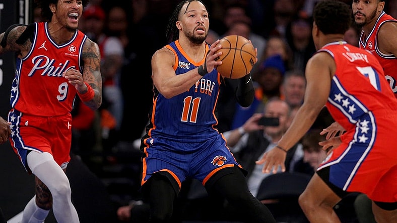 Mar 10, 2024; New York, New York, USA; New York Knicks guard Jalen Brunson (11) looks to pass the ball against Philadelphia 76ers guard Kelly Oubre Jr. (9) and forward Tobias Harris (12) and guard Kyle Lowry (7) during the second quarter at Madison Square Garden. Mandatory Credit: Brad Penner-USA TODAY Sports