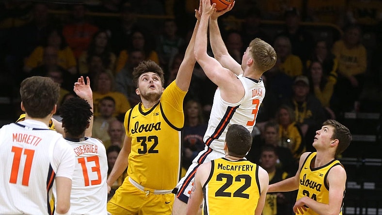 Iowa   s Owen Freeman (32) blocks Illinois    Marcus Domask (3) Sunday, March 10, 2024 at Carver-Hawkeye Arena in Iowa City, Iowa.