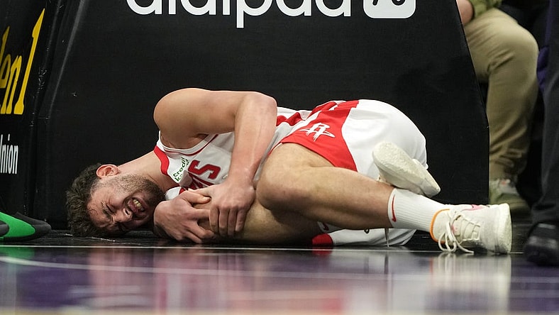 Mar 10, 2024; Sacramento, California, USA; Houston Rockets center Alperen Sengun (28) lies on the court after suffering an injury against the Sacramento Kings during the fourth quarter at Golden 1 Center. Mandatory Credit: Darren Yamashita-USA TODAY Sports
