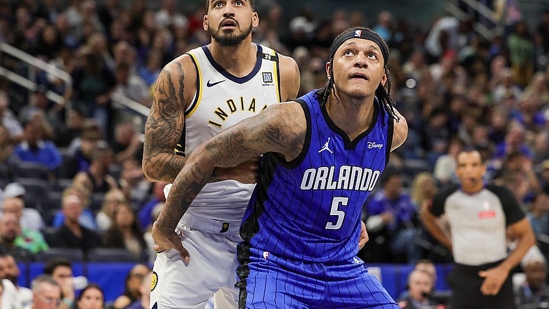 Mar 10, 2024; Orlando, Florida, USA; Orlando Magic forward Paolo Banchero (5) and Indiana Pacers forward Obi Toppin (1) look for the rebound during the second half at KIA Center. Mandatory Credit: Mike Watters-USA TODAY Sports