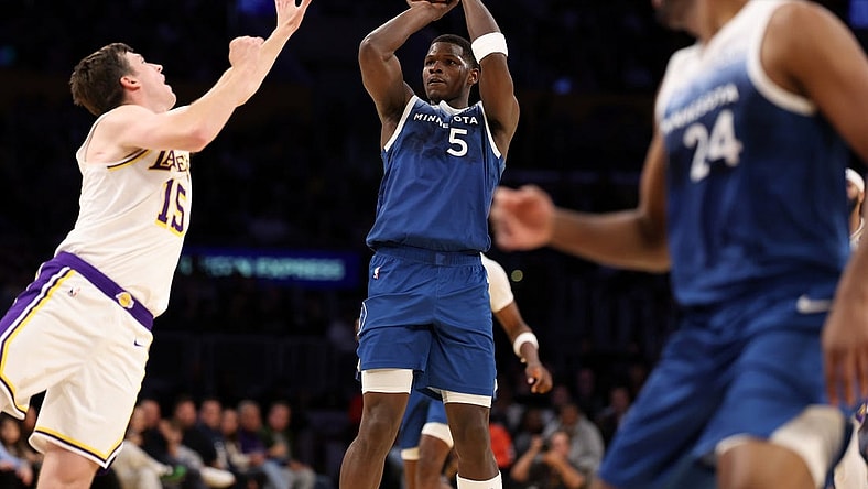 Mar 10, 2024; Los Angeles, California, USA;  Minnesota Timberwolves guard Anthony Edwards (5) shoots the ball over Los Angeles Lakers guard Austin Reaves (15) during the fourth quarter at Crypto.com Arena. Mandatory Credit: Kiyoshi Mio-USA TODAY Sports