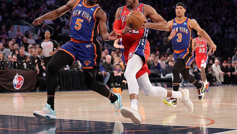 Mar 10, 2024; New York, New York, USA; Philadelphia 76ers forward Tobias Harris (12) drives to the basket against New York Knicks forward Precious Achiuwa (5) and guard Josh Hart (3) during the first quarter at Madison Square Garden. Mandatory Credit: Brad Penner-USA TODAY Sports