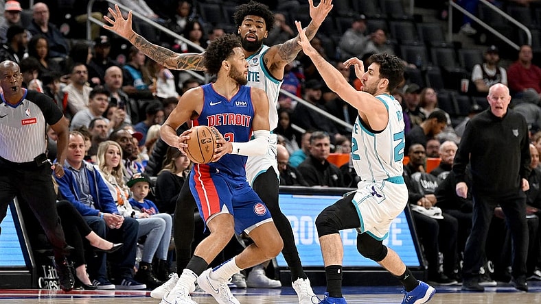 Mar 11, 2024; Detroit, Michigan, USA;   Detroit Pistons guard Cade Cunningham (2) is double teamed by Charlotte Hornets guard Vasilije Micic (22) and center Nick Richards (4) in the first quarter at Little Caesars Arena. Mandatory Credit: Lon Horwedel-USA TODAY Sports