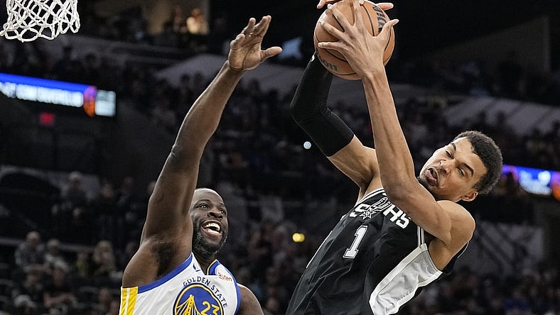 Mar 11, 2024; San Antonio, Texas, USA; San Antonio Spurs forward Victor Wembanyama (1) grabs a rebound away from Golden State Warriors forward Draymond Green (23) during the first half at Frost Bank Center. Mandatory Credit: Scott Wachter-USA TODAY Sports