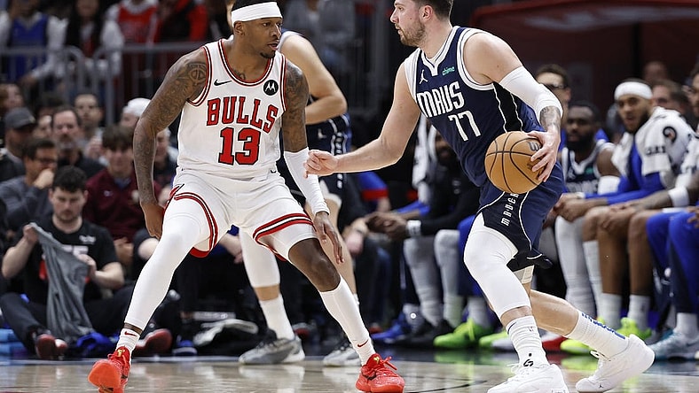Mar 11, 2024; Chicago, Illinois, USA; Dallas Mavericks guard Luka Doncic (77) drives to the basket against Chicago Bulls forward Torrey Craig (13) during the first half at United Center. Mandatory Credit: Kamil Krzaczynski-USA TODAY Sports