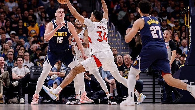 Mar 11, 2024; Denver, Colorado, USA; Denver Nuggets center Nikola Jokic (15) passes the ball to guard Jamal Murray (27) as Toronto Raptors forward Bruce Brown (11) and center Jontay Porter (34) defend in the second quarter at Ball Arena. Mandatory Credit: Isaiah J. Downing-USA TODAY Sports