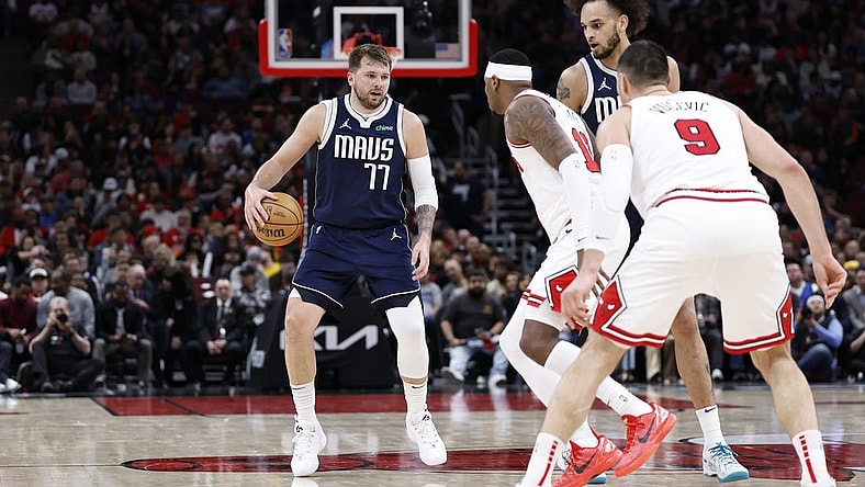 Mar 11, 2024; Chicago, Illinois, USA; Dallas Mavericks guard Luka Doncic (77) brings the ball up court against the Chicago Bulls during the second half at United Center. Mandatory Credit: Kamil Krzaczynski-USA TODAY Sports