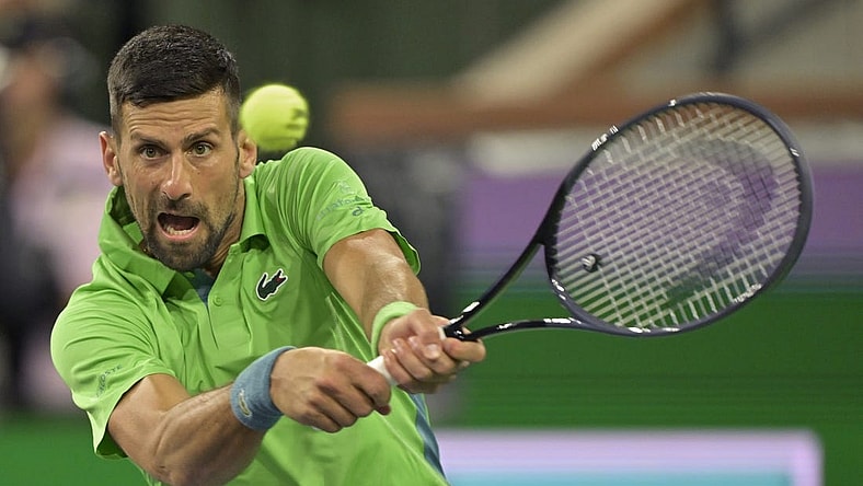 Mar 11, 2024; Indian Wells, CA, USA;  Novak Djokovic (SRB) hits a shot in his third round match against Luca Nardi (ITA) in the BNP Paribas Open at the Indian Wells Tennis Garden. Mandatory Credit: Jayne Kamin-Oncea-USA TODAY Sports
