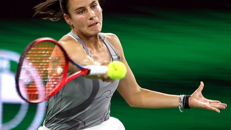 Emma Navarro returns to Elina Svitolina during their third-round match at the BNP Paribas Open in Indian Wells, Calif., on Monday, March 11, 2024.