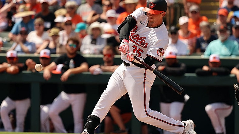 Mar 12, 2024; Sarasota, Florida, USA; Baltimore Orioles catcher Adley Rutschman (35) hits a RBI single during the second inning against the Tampa Bay Rays at Ed Smith Stadium. Mandatory Credit: Kim Klement Neitzel-USA TODAY Sports