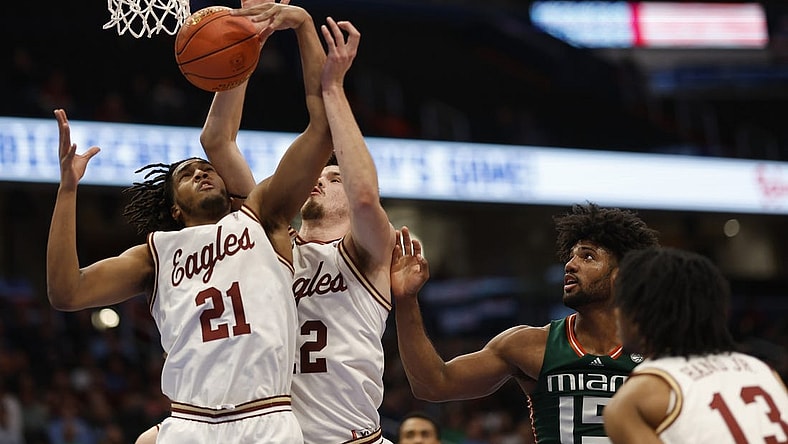Mar 12, 2024; Washington, D.C., USA; Boston College Eagles forward Devin McGlockton (21) and College Eagles forward Quinten Post (12) reach for a rebound in front of Miami (Fl) Hurricanes forward Norchad Omier (15) in the first half at Capital One Arena. Mandatory Credit: Geoff Burke-USA TODAY Sports