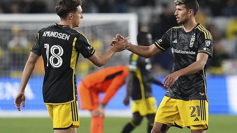 Mar 12, 2024; Columbus, OH, USA;  Columbus Crew defender Malte Amundsen (18) celebrates the win with defender Yevhen Cheberko (21) following the Concacaf Champions Cup soccer game against the Houston Dynamo at Lower.com Field. Mandatory Credit: Adam Cairns-USA TODAY Sports