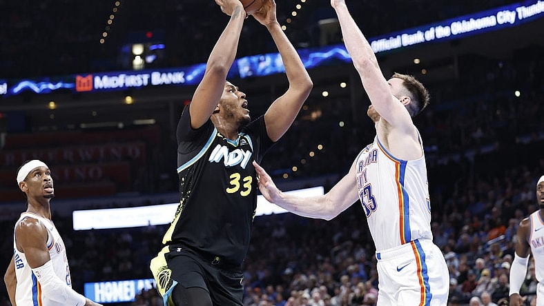 Mar 12, 2024; Oklahoma City, Oklahoma, USA; Indiana Pacers center Myles Turner (33) shoots as Oklahoma City Thunder forward Gordon Hayward (33) defends during the second half at Paycom Center. Mandatory Credit: Alonzo Adams-USA TODAY Sports