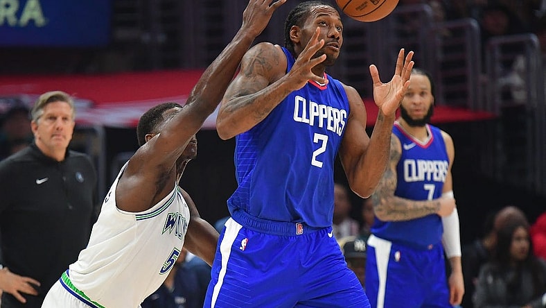Mar 12, 2024; Los Angeles, California, USA; Los Angeles Clippers forward Kawhi Leonard (2) loses the ball against Minnesota Timberwolves guard Anthony Edwards (5) during the first half at Crypto.com Arena. Mandatory Credit: Gary A. Vasquez-USA TODAY Sports