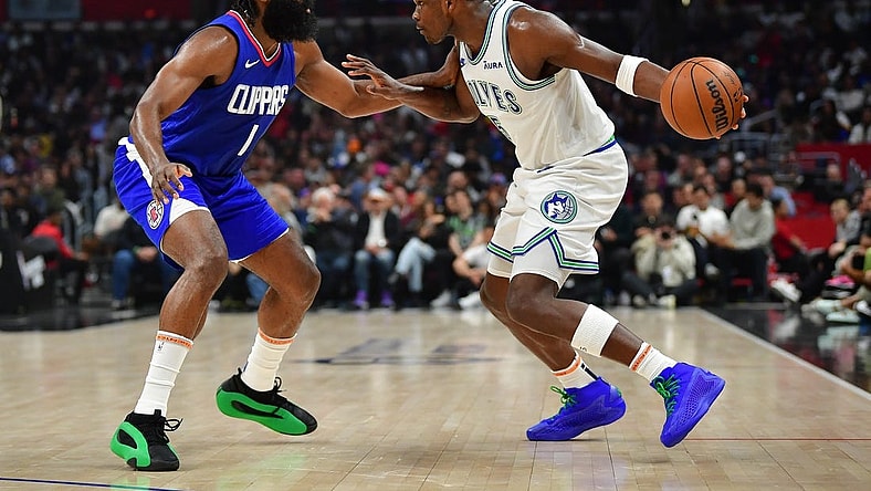 Mar 12, 2024; Los Angeles, California, USA; Minnesota Timberwolves guard Anthony Edwards (5) controls the ball against Los Angeles Clippers guard James Harden (1) during the first half at Crypto.com Arena. Mandatory Credit: Gary A. Vasquez-USA TODAY Sports