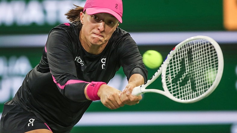 Iga Swiatek hits a shot in her win over Yulia Putintseva during the BNP Paribas Open in Indian Wells, Calif., March 12, 2024.