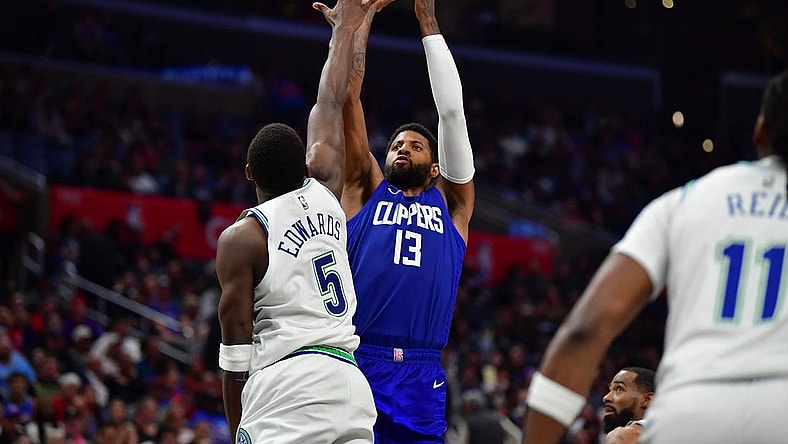 Mar 12, 2024; Los Angeles, California, USA; Los Angeles Clippers forward Paul George (13) shoots against Minnesota Timberwolves guard Anthony Edwards (5) during the second half at Crypto.com Arena. Mandatory Credit: Gary A. Vasquez-USA TODAY Sports