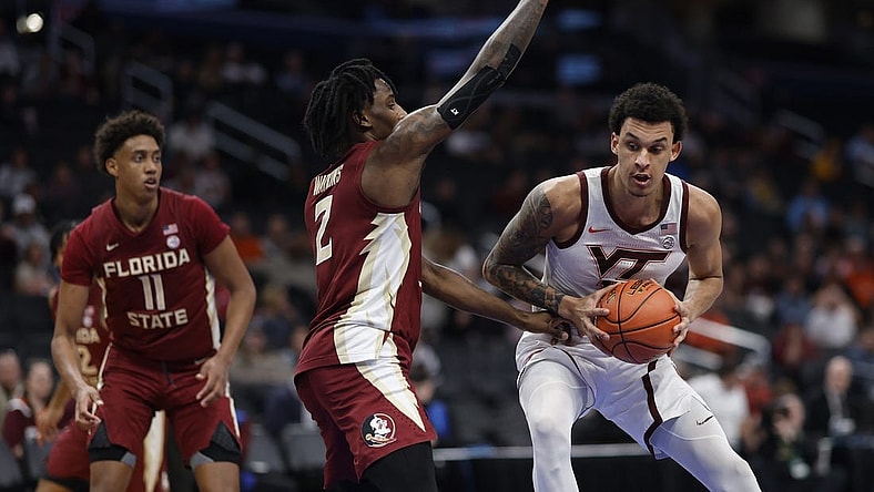 Mar 13, 2024; Washington, D.C., USA; Virginia Tech Hokies center Lynn Kidd (15) drives to the basket as Florida State Seminoles forward Jamir Watkins (2) defends in the first half at Capital One Arena. Mandatory Credit: Geoff Burke-USA TODAY Sports