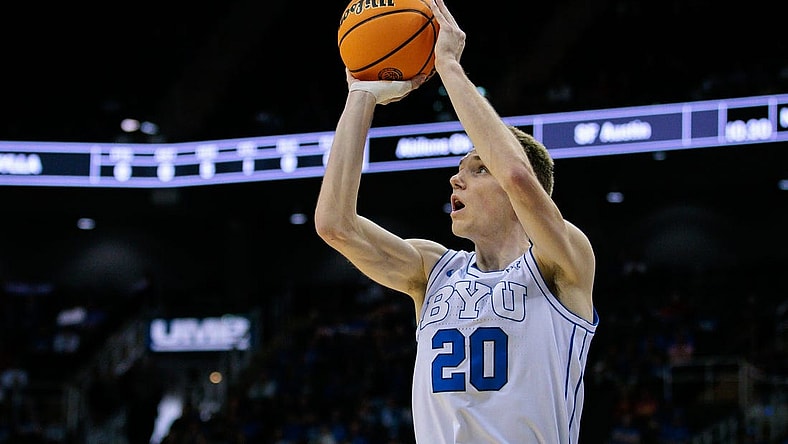 Mar 13, 2024; Kansas City, MO, USA; Brigham Young Cougars guard Spencer Johnson (20) shoots the ball during the first half against the UCF Knights at T-Mobile Center. Mandatory Credit: William Purnell-USA TODAY Sports