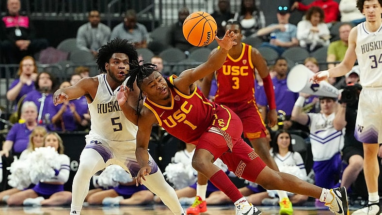 Mar 13, 2024; Las Vegas, NV, USA; USC Trojans guard Isaiah Collier (1) loses control of the ball near Washington Huskies guard Sahvir Wheeler (5) during the first half at T-Mobile Arena. Mandatory Credit: Stephen R. Sylvanie-USA TODAY Sports