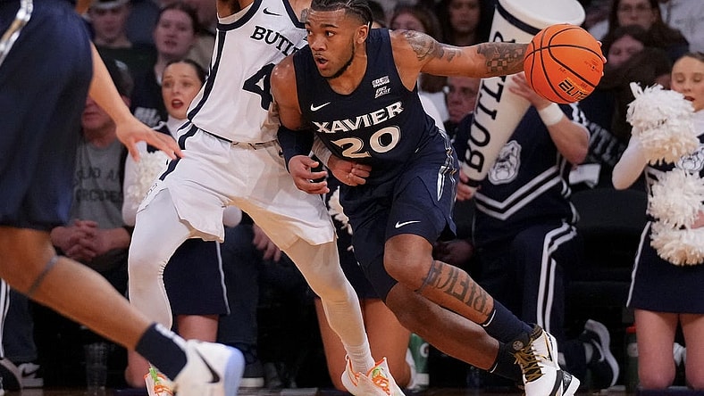 Mar 13, 2024; New York City, NY, USA; Xavier Musketeers guard Dayvion McKnight (20) drives on Butler Bulldogs guard DJ Davis (4) during the first half at Madison Square Garden. Mandatory Credit: Robert Deutsch-USA TODAY Sports