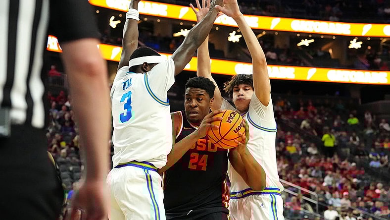 Mar 13, 2024; Las Vegas, NV, USA; Oregon State Beavers center KC Ibekwe (24) looks to shoot between UCLA Bruins forward Adem Bona (3) and UCLA Bruins forward Berke Buyuktuncel (9) during the first half at T-Mobile Arena. Mandatory Credit: Stephen R. Sylvanie-USA TODAY Sports